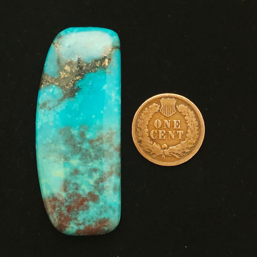 "Trapezoid Nacozari Mine Turquoise Cabochon with Black Matrix, Pyrite, and Clouds of Red Matrix, 65.30 Carats, 54mm x 22.15mm, Stabilized, from Nacozari Mine on Turquoise Deluxe"