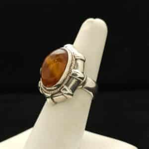 "A solid silver ring featuring a natural Baltic amber stone, picked from the shores of the Baltic Ocean, size 7, part of the Ethnographic line by Turquoise Deluxe."