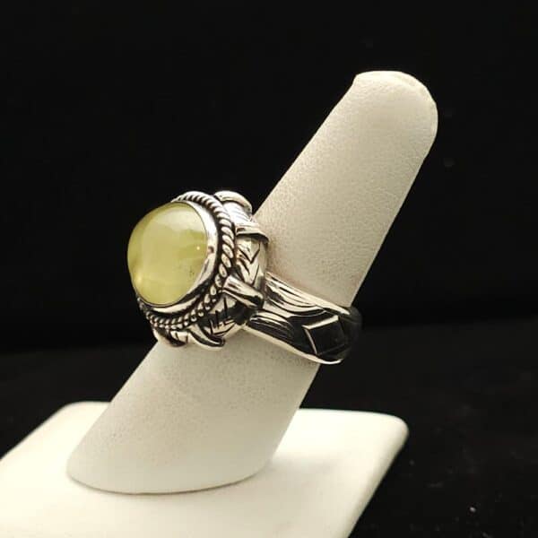 "A heavy silver ring featuring an oval prehnite stone from Australia, size 7.5, part of the Ethnographic line by Turquoise Deluxe."