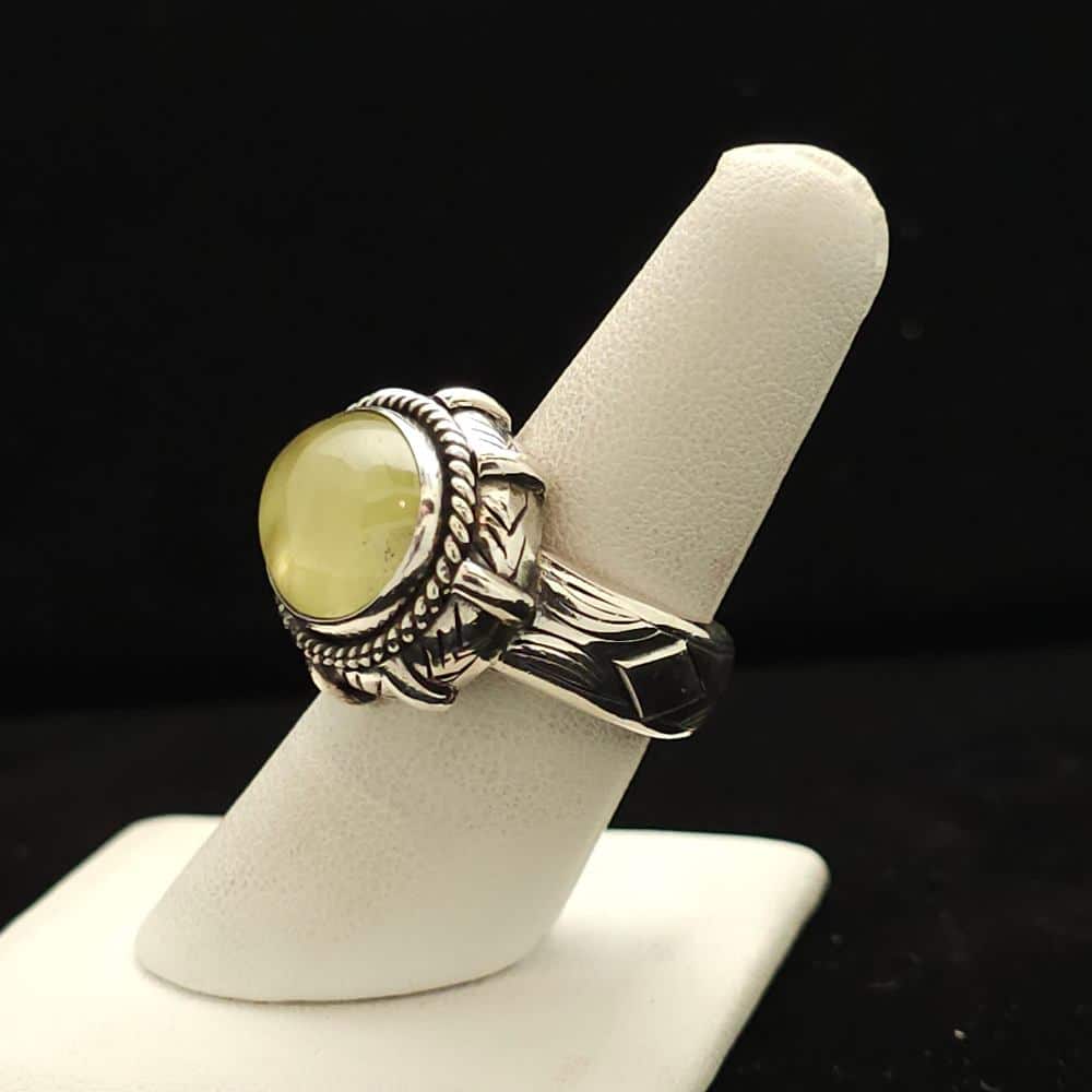 "A heavy silver ring featuring an oval prehnite stone from Australia, size 7.5, part of the Ethnographic line by Turquoise Deluxe."