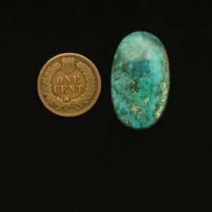 Vintage Godber-Burnham DryCreek turquoise cabochon, 24.00 carats, oval-shaped, with cerulean blue hues and wisps of black matrix, hand-cut from 1970s Nevada rough.