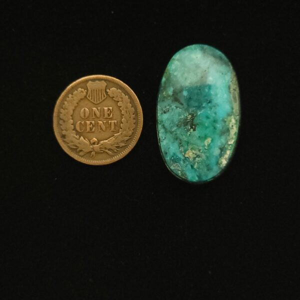 Vintage Godber-Burnham DryCreek turquoise cabochon, 24.00 carats, oval-shaped, with cerulean blue hues and wisps of black matrix, hand-cut from 1970s Nevada rough.