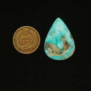 Vintage Godber-Burnham turquoise cabochon, 25.00 carats, teardrop-shaped, with ocean surge blue hues and black and golden matrix, hand-cut from 1970s Nevada rough.