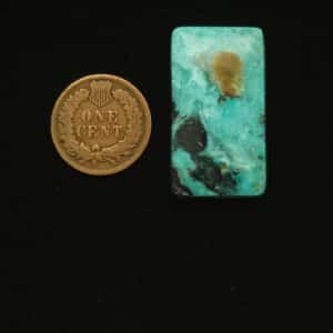 Rectangular Godber-Burnham turquoise cabochon in ocean surf blue with black and golden matrix, 37.90 carats