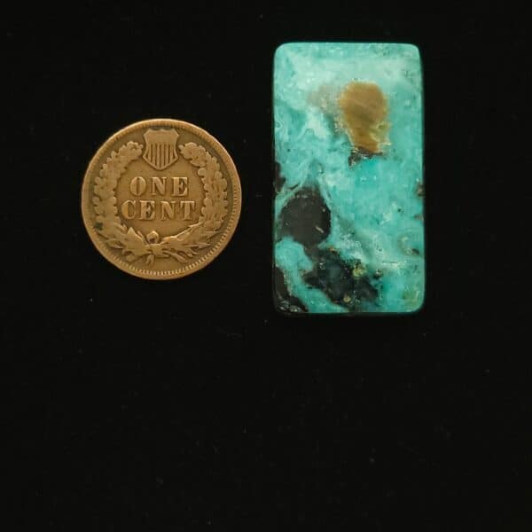 Rectangular Godber-Burnham turquoise cabochon in ocean surf blue with black and golden matrix, 37.90 carats