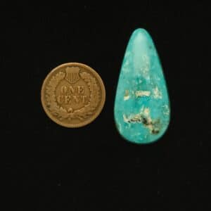Elongated teardrop Godber-Burnham turquoise cabochon in sea blue with white and blue matrix and natural pits, 27.75 carats