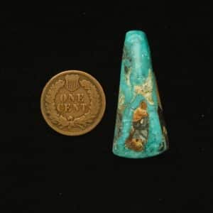 Elongated teardrop Godber-Burnham turquoise cabochon in deep ocean blue with black, gold, and white matrix, 28.70 carats