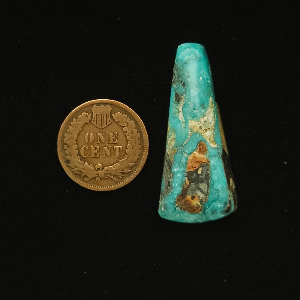 Elongated teardrop Godber-Burnham turquoise cabochon in deep ocean blue with black, gold, and white matrix, 28.70 carats