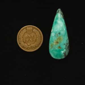 Elongated teardrop Godber-Burnham turquoise cabochon in ocean froth blue with black and gold matrix, 28.85 carats