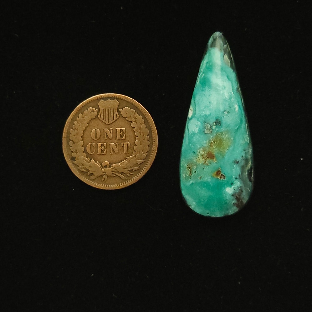 Elongated teardrop Godber-Burnham turquoise cabochon in ocean froth blue with black and gold matrix, 28.85 carats