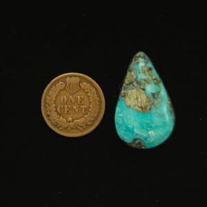 Teardrop-shaped Godber-Burnham turquoise cabochon in ocean surge blue with black and grey chert matrix, 27.40 carats