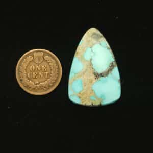 Natural Godber-Burnham turquoise cabochon, 26.45 carats, elongated triangle shape, sky blue with grey and black matrix