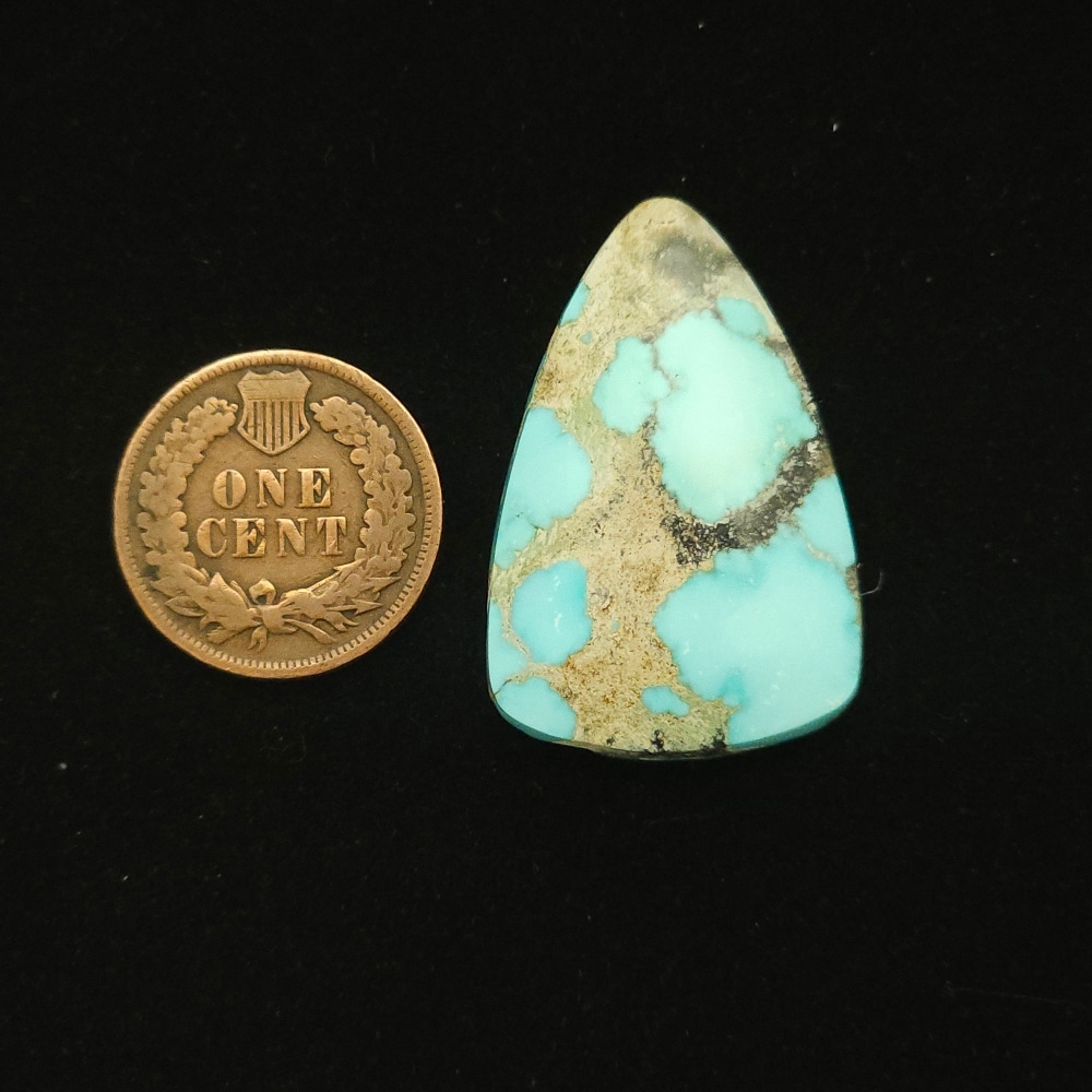 Natural Godber-Burnham turquoise cabochon, 26.45 carats, elongated triangle shape, sky blue with grey and black matrix