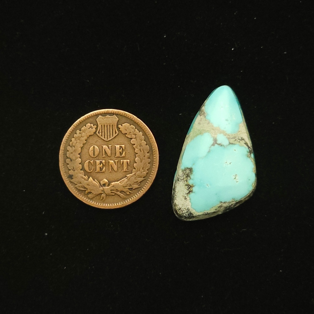 Natural Godber-Burnham turquoise cabochon, 16.70 carats, isosceles triangle shape, sky blue with black and grey wispy matrix