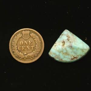 Dry Creek turquoise cabochon, 11.30 carats, fan-shaped, pastel blue with ochre spiderweb matrix