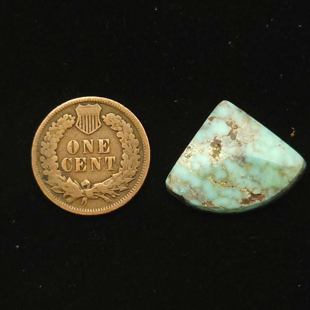 Dry Creek turquoise cabochon, 11.30 carats, fan-shaped, pastel blue with ochre spiderweb matrix
