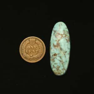 Dry Creek turquoise cabochon, 34.00 carats, elongated oval shape, pastel sky blue with ochre matrix