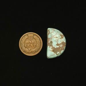 Dry Creek turquoise cabochon, 19.45 carats, half moon shape, pastel blue with ochre matrix