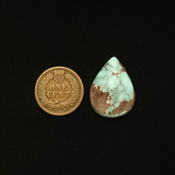 Dry Creek turquoise cabochon, 19.10 carats, teardrop shape, pale blue with purple-brown spiderweb matrix