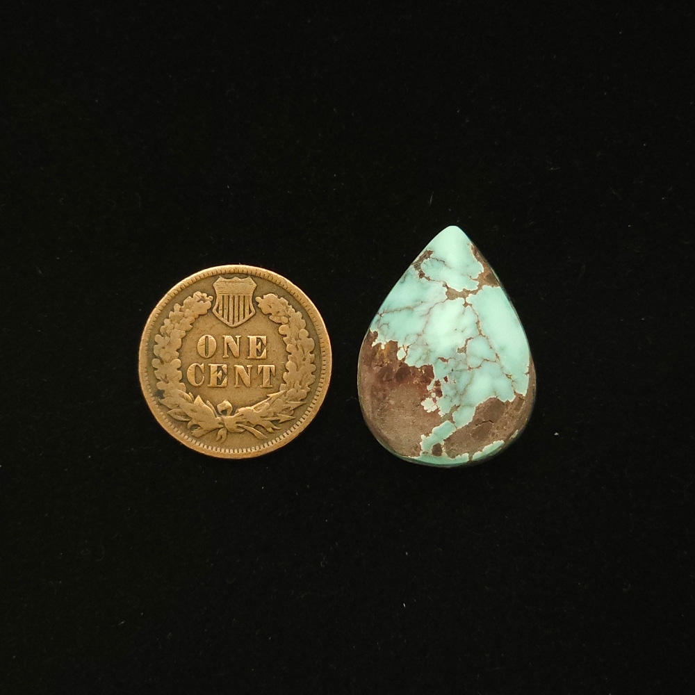 Dry Creek turquoise cabochon, 19.10 carats, teardrop shape, pale blue with purple-brown spiderweb matrix